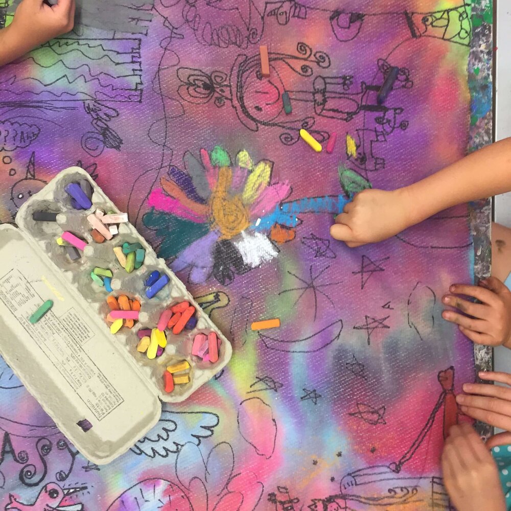 Tweens and teens working on mixed-media art at an outdoor table at Pachis art studio, Linda Vista, San Diego